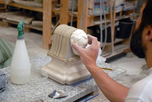 Reconstruction cross and angels head, build up in clay